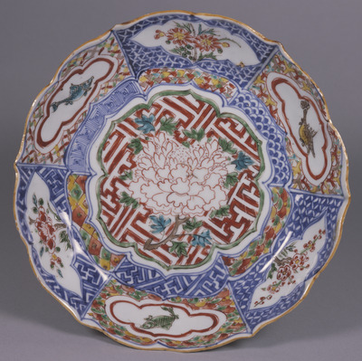 Flower-shaped Dish with Peonies, Flowering Plants, and Fish in Underglaze Blue and Overglaze Enamels (Iroe Shonzui) Image