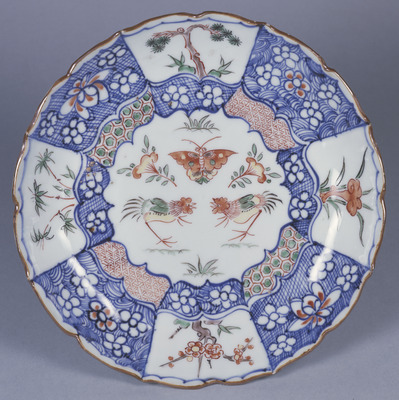 Cusped Dish with Flowering Plants, Butterfly, and Fighting Roosters in Iroe Shonzui (Underglaze Blue and Overglaze Enamels) Image