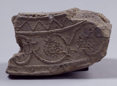 Fragment of Flat Eaves Tile with Grapes Arabesque Excavated from Mount Kaina Image